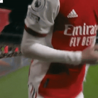 Soccer Player Hugging Teammate In Red And White Jersey GIF