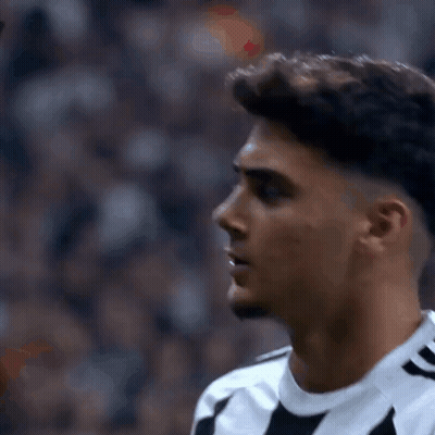 Soccer Player In Black And White Striped Shirt Looking At Camera GIF