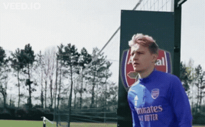 Soccer Player In Blue Emirates Shirt Standing In Front Of Sign GIF