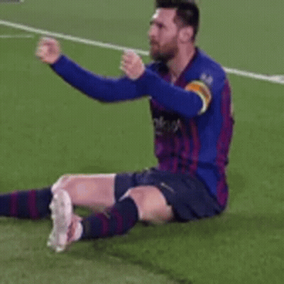 Soccer Player In Blue Shirt Sitting On Grass GIF