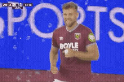 Soccer Player In Burgundy Shirt Celebrating Goal GIF