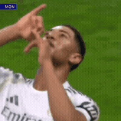 Soccer Player In Fly Emirates Jersey Pointing Up GIF