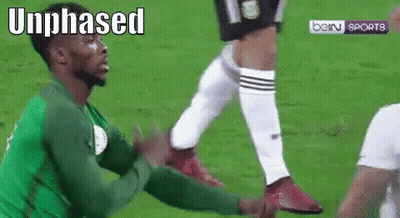 Soccer Player In Green Jersey Being Tackled GIF