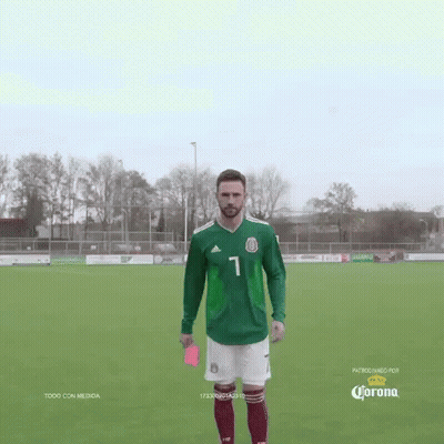 Soccer Player In Green Jersey Holds Red Card GIF