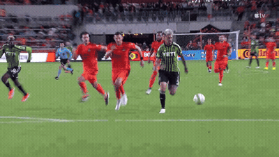 Soccer Player In Green Yeti Jersey Kicking Ball GIF