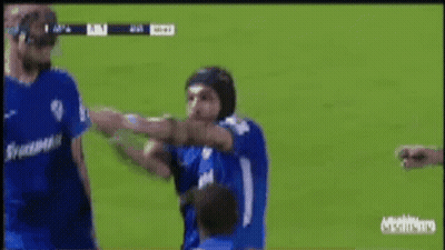 Soccer Player In Helmet Punched By Another Player GIF