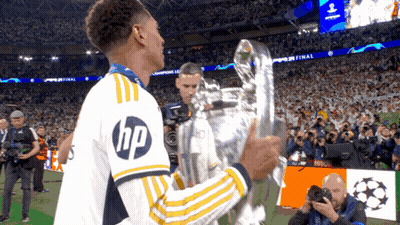 Soccer Player In HP Shirt Holding Trophy GIF