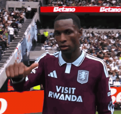 Soccer Player In Maroon Jersey Saying Visit Rwanda GIF