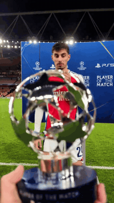 Soccer Player In Mira Jersey Holding Trophy GIF
