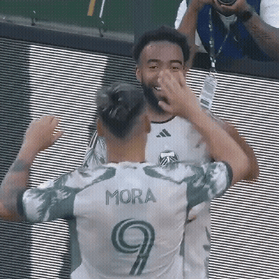 Soccer Player In Number 9 Jersey Hugging Another Player GIF