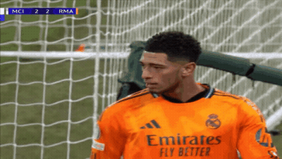 Soccer Player in Orange Jersey Emirates Fly Better