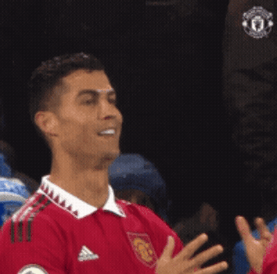 Soccer Player In Red Adidas Jersey Smiling And Clapping GIF