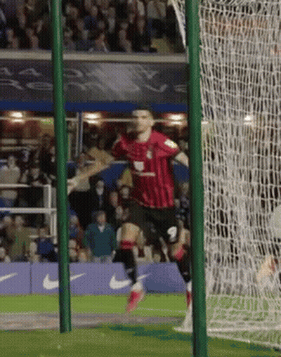 Soccer Player In Red And Black Celebrating Goal GIF