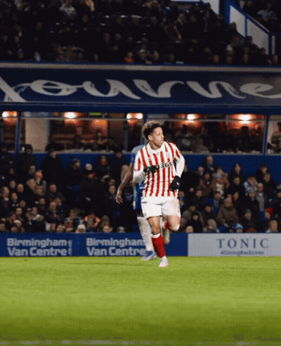 Soccer Player In Red And White Jersey Running Past Birmingham Ad GIF