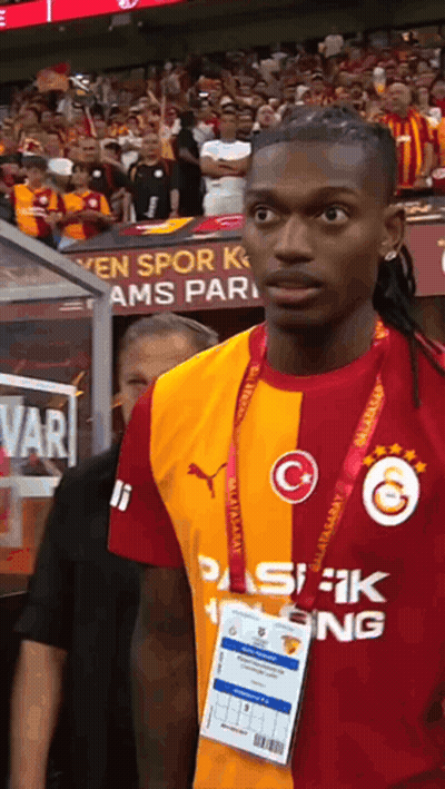 Soccer Player In Red And Yellow Jersey With Letter G GIF
