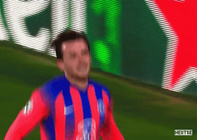 Soccer Player In Red Blue White Striped Shirt In Front Of Heineken Sign GIF