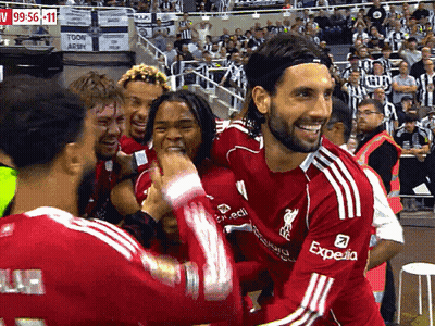 Soccer Player In Red Expedia Jersey Surrounded By Players GIF