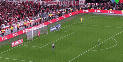 Soccer Player In Red Jersey And White Gloves Standing In Front Of Goal GIF
