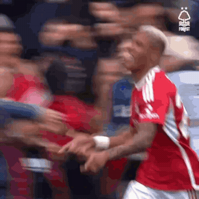 Soccer Player In Red Jersey Shaking Hands With Fan GIF