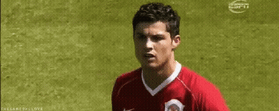 Soccer Player In Red Jersey Standing On Field GIF
