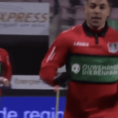 Soccer Player In Red Jersey With Green Ouwehand Dierenpark Patch GIF