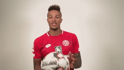 Soccer Player In Red Shirt Holding Ball GIF