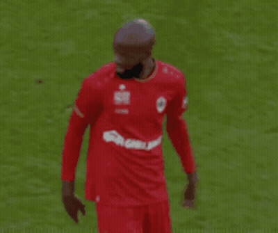 Soccer Player In Red Shirt Pointing At Field GIF