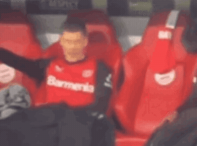 Soccer Player In Red Shirt Sitting In Stands GIF
