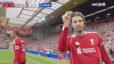 Soccer Player In Red Standard Chartered Jersey Celebrates Goal GIF