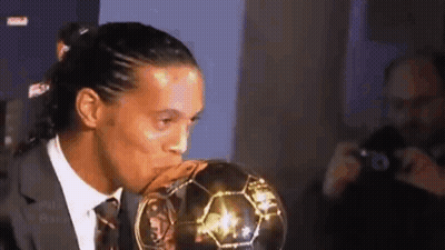 Soccer Player In Suit Kissing Ball GIF