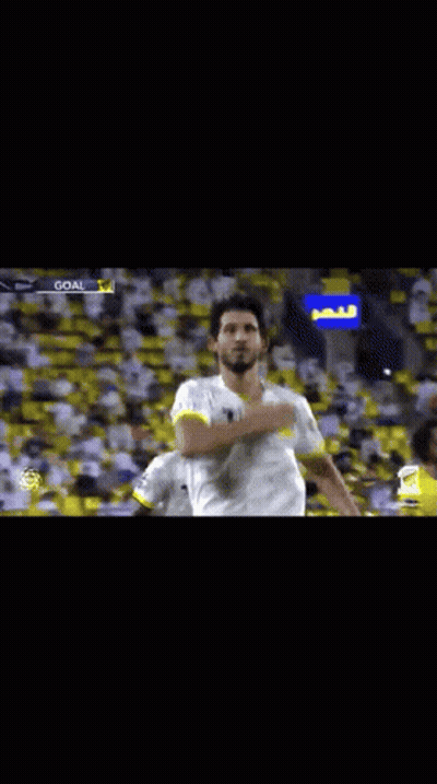 Soccer Player In White And Yellow Jersey Raising Arm GIF