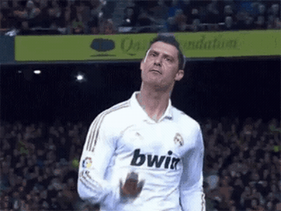 Soccer Player In White Jersey With Bwin In Front Of Crowd GIF