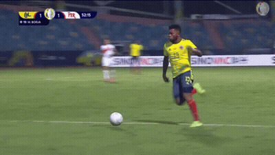 Soccer Player In Yellow Jersey Number 19 Kicking Ball GIF