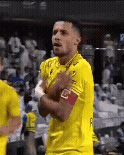 Soccer Player In Yellow Jersey With Hands In Pockets GIF