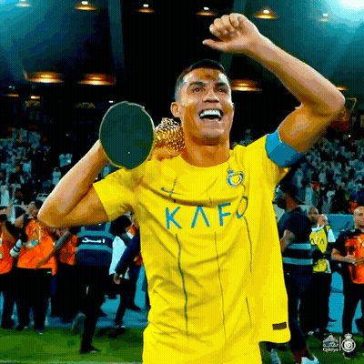 Soccer Player In Yellow Kafo Jersey Holding Trophy Over Head GIF