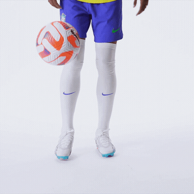 Soccer Player Kicking Ball In Blue Shorts And White Socks GIF