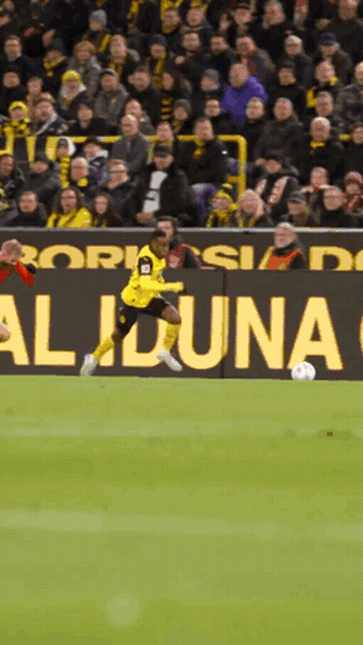 Soccer Player Kicking Ball In Front Of Aliona Sign GIF