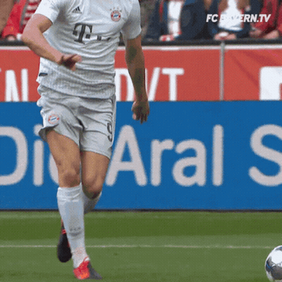 Soccer Player Kicking Ball In Front Of Aral S Sign GIF