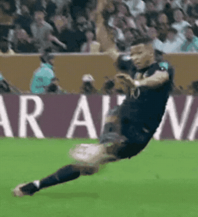 Soccer Player Kicking Ball In Front Of Aran Sign GIF