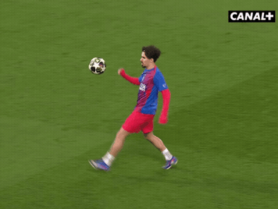 Soccer Player Kicking Ball In Front Of Canal+ Sign GIF