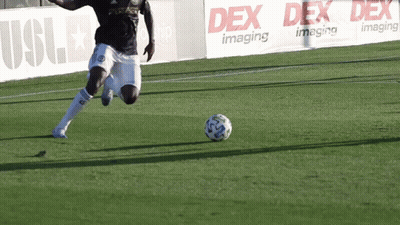 Soccer Player Kicking Ball In Front Of Dex Imaging Banner GIF