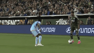 Soccer Player Kicking Ball In Front Of Hyundai Sign GIF