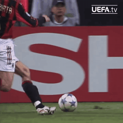 Soccer Player Kicking Ball In Front Of UEFA.tv Sign GIF