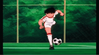 Soccer Player Kicking Ball on Field