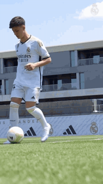 Soccer Player Kicking Ball On Field With Building GIF