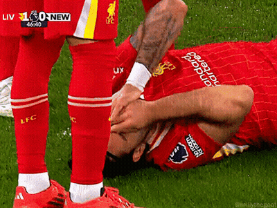 Soccer Player Laying On Ground Being Helped Up GIF