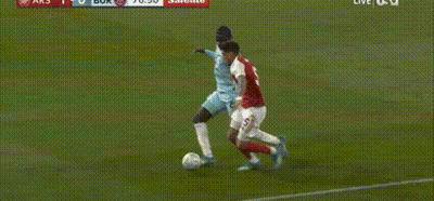 Soccer Player Lying As Another Kicks Ball GIF