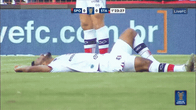 Soccer Player Lying On Field With Live FC Advertisement GIF