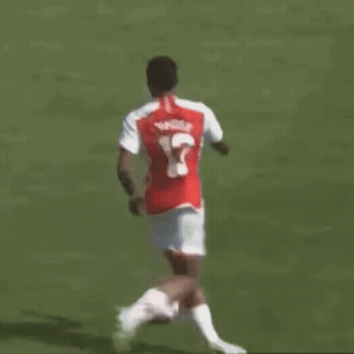Soccer Player Number 12 Kicking Ball GIF