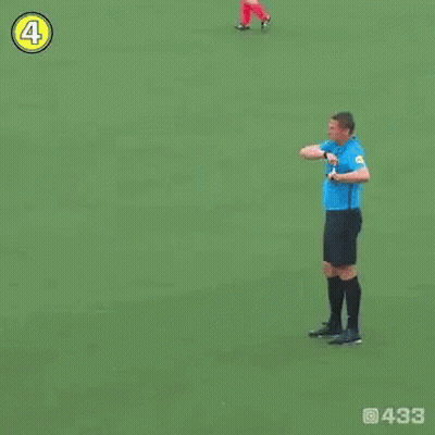 Soccer Player Number 4 Standing Next To Referee GIF